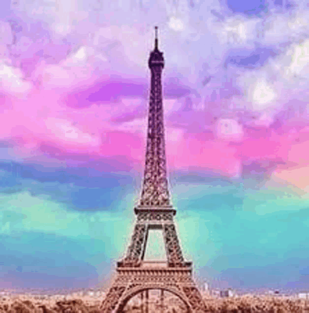 the eiffel tower is surrounded by a pink and blue sky .