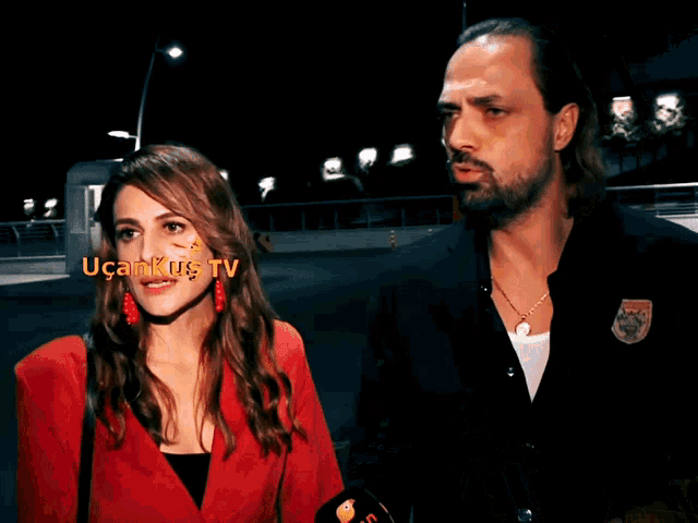 a man and a woman are standing next to each other and the man is wearing a shirt that says ucan kus
