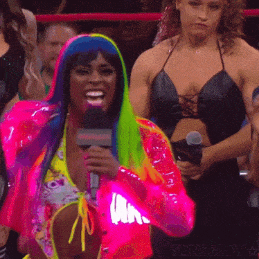 a woman in a bikini is holding a microphone in front of a sign that says missglow