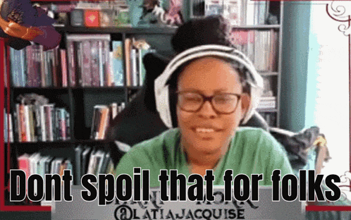a woman wearing headphones and glasses is sitting in front of a bookshelf and says do n't spoil that for folks