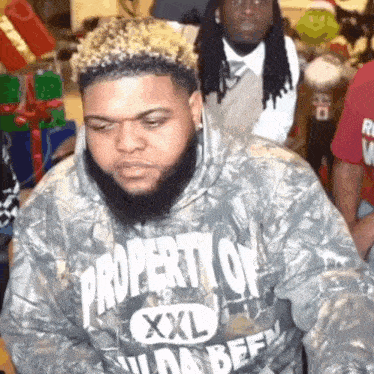 a man with a beard wearing a property of xxl shirt