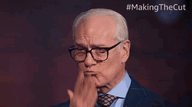 a man wearing glasses and a suit has the hashtag #makingthecut on the bottom