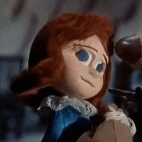 a close up of a doll 's face with red hair and blue eyes