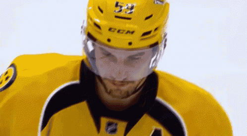 a close up of a hockey player wearing a helmet that says ccm