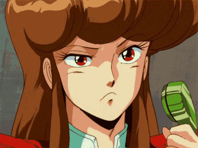 a girl with brown hair and red eyes is holding a green object in her hand