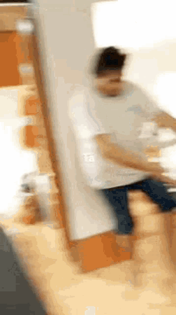 a blurry picture of a man sitting on a couch