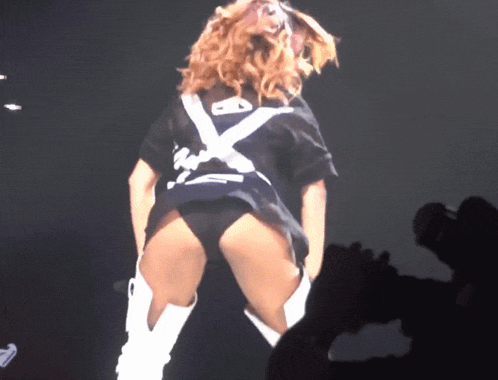 a woman in a black shirt with a white x on the back