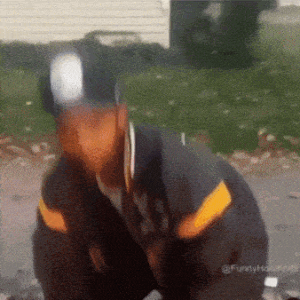 a blurry picture of a man wearing a hat and a jacket with the word funny on it