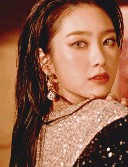 a close up of a woman 's face with earrings on