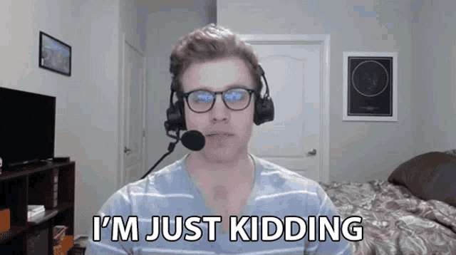 a man wearing headphones and a microphone says i 'm just kidding