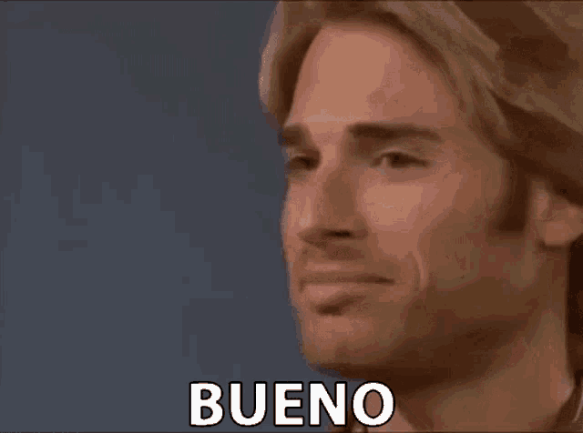 a close up of a man 's face with the words vamos on it .