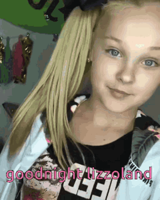a girl with blonde hair is wearing a black shirt that says goodnight tizzoland
