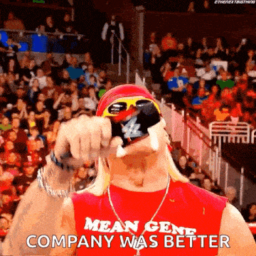 a wrestler in a red shirt that says mean gene company was better