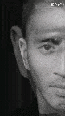 a black and white photo of a man 's face with the caption capcut on the bottom