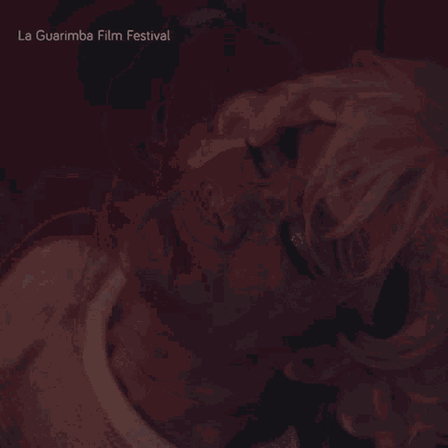 a blurred image of a person 's hands with the words la guarimba film festival visible