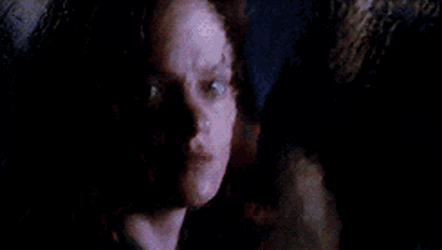a close up of a woman 's face with a serious look on her face .