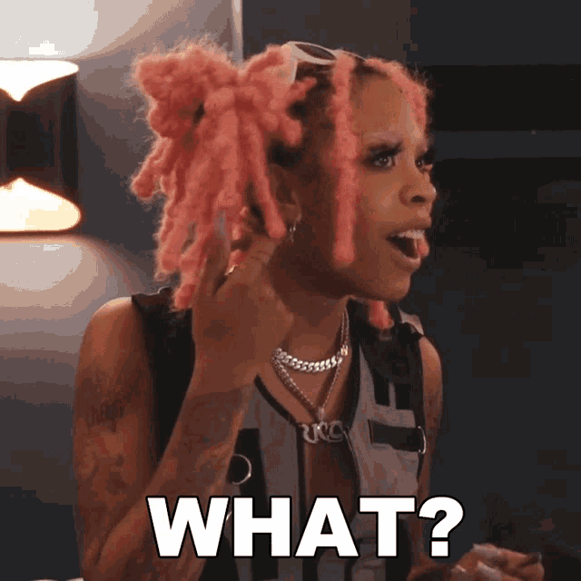 a woman with pink hair is making a funny face and the word what is above her