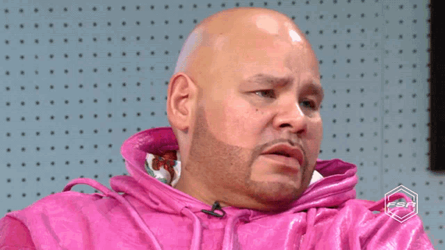 a bald man in a pink jacket is screaming that nobody gives me shit