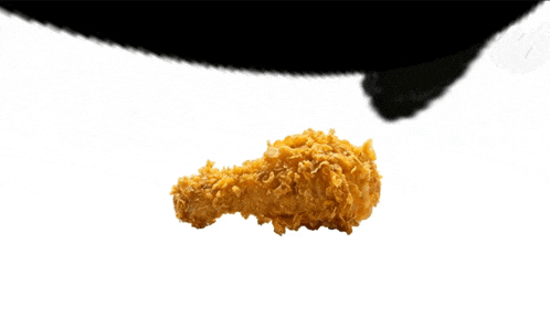 a piece of fried chicken is floating in the air on a white background