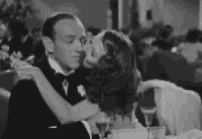 a black and white photo of a man and a woman hugging