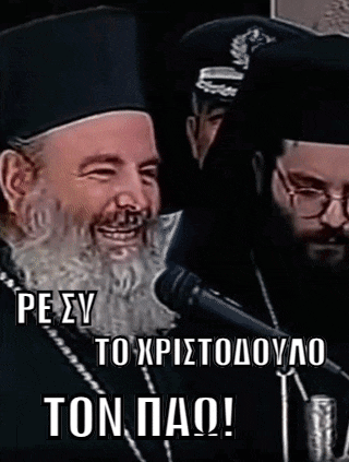 a man with a beard is smiling in front of a microphone while another man stands behind him .