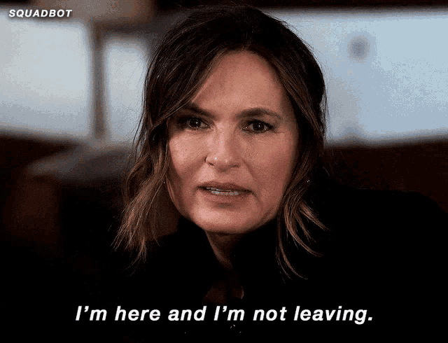 a woman says " i 'm here and i 'm not leaving " in front of a squadbot logo