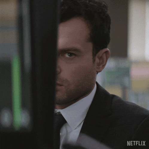 a man in a suit and tie is behind a netflix advertisement