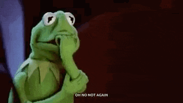 kermit the frog from the muppet show is holding his hand to his face .