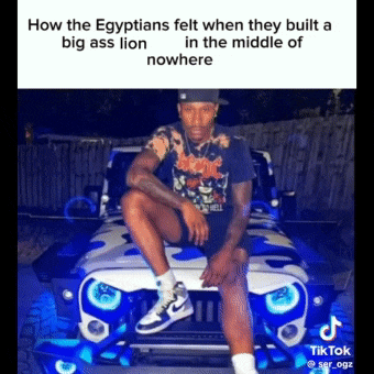 a man is sitting in front of a jeep that has blue lights on the front .