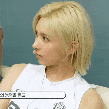 a girl with blonde hair is wearing a white tank top and headphones .