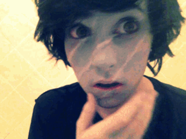 a close up of a person 's face with a surprised look on it