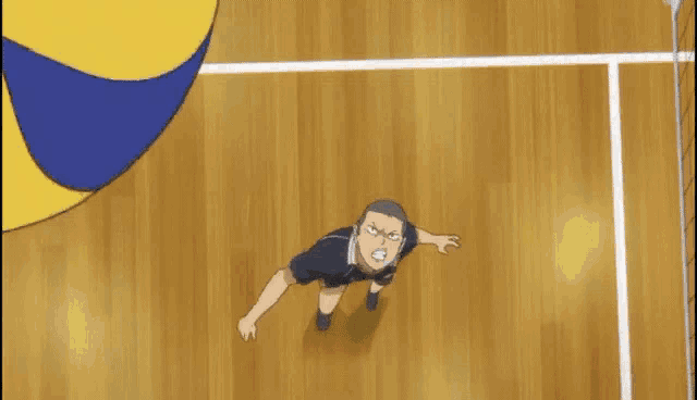 a man with a shaved head stands in front of a volleyball net