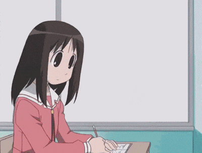 a girl sits at a desk in front of a white board