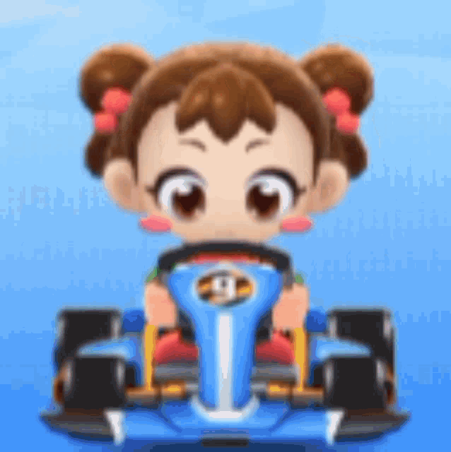 a little girl is driving a blue race car .