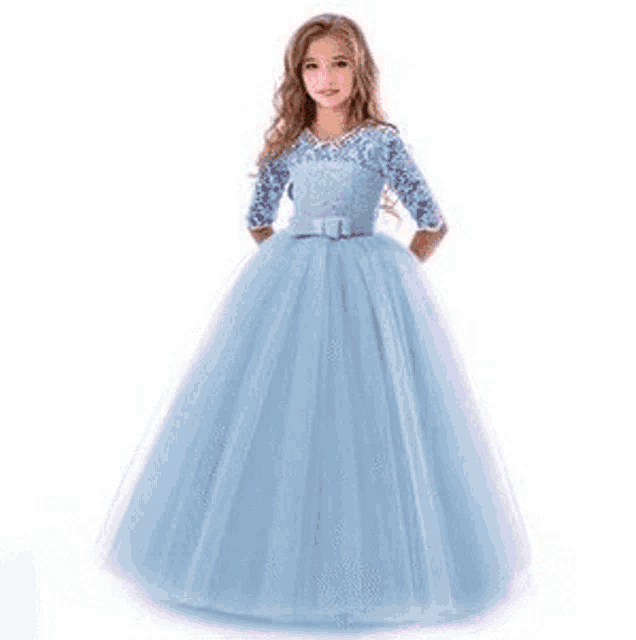 a little girl is wearing a purple dress with long sleeves and a bow .