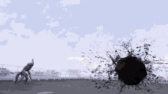 a man is standing in front of a large black object that is exploding .