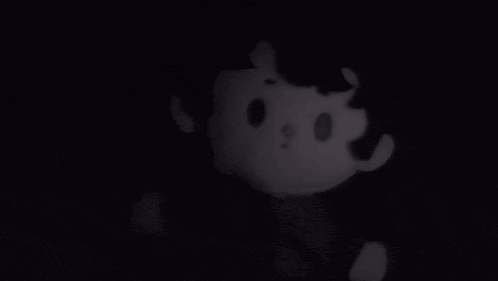 a close up of a person 's hand in the dark with a blurred background .