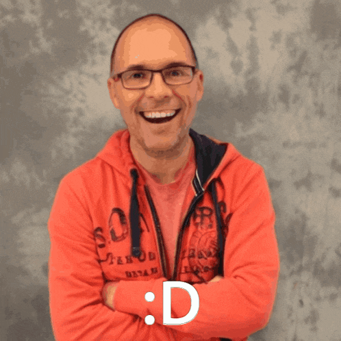 a man wearing a red sweatshirt with the letter d on the bottom