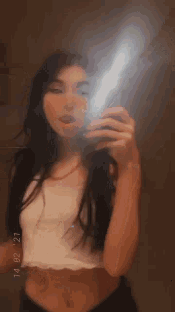a young woman is taking a selfie in a mirror .