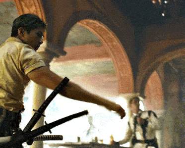 a man in a white shirt is holding a sword in his right hand