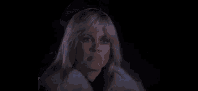 a close up of a person 's face with a light coming out of their eye .