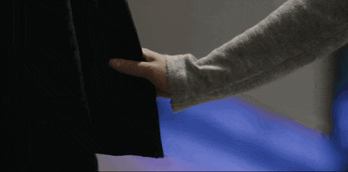 a close up of a person 's arm holding a black object