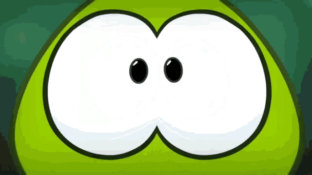 a close up of a green cartoon character 's eyes on a green background