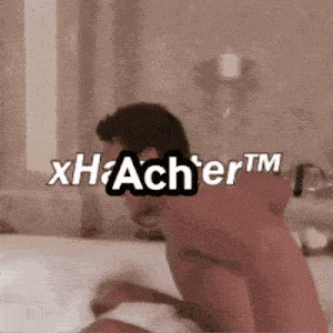a shirtless man is laying on a bed with the words xhacher tm on the bottom