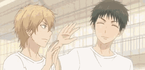 a couple of anime characters are standing next to each other and hugging each other .