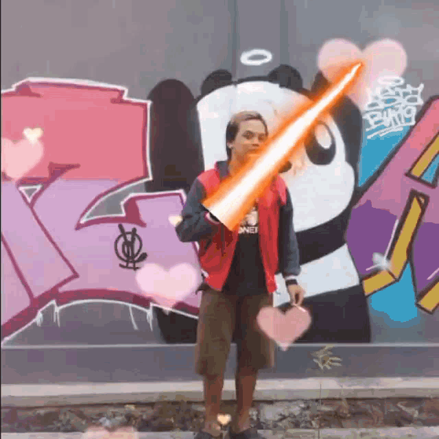a man in a red jacket is holding a red light saber
