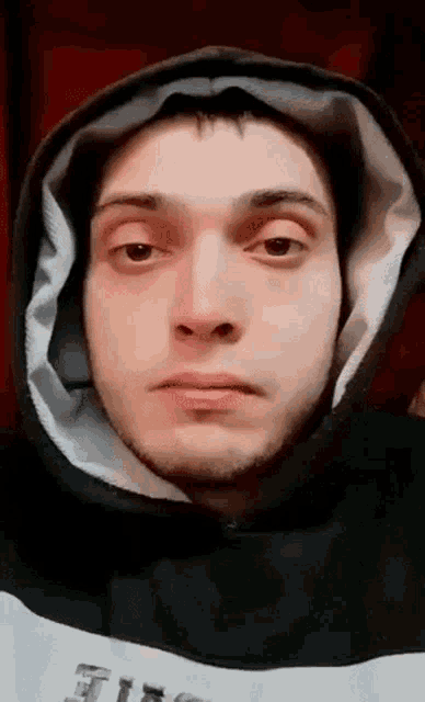 a close up of a man wearing a hooded sweatshirt