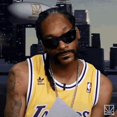 snoop dogg is wearing sunglasses and a yellow lakers jersey