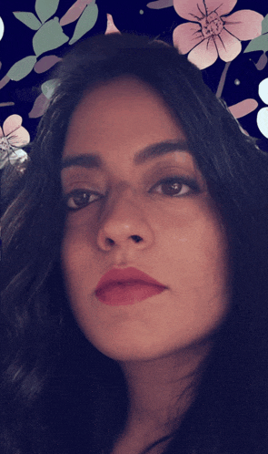 a close up of a woman 's face with flowers around her