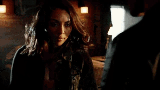 a man and a woman are holding hands in a room .